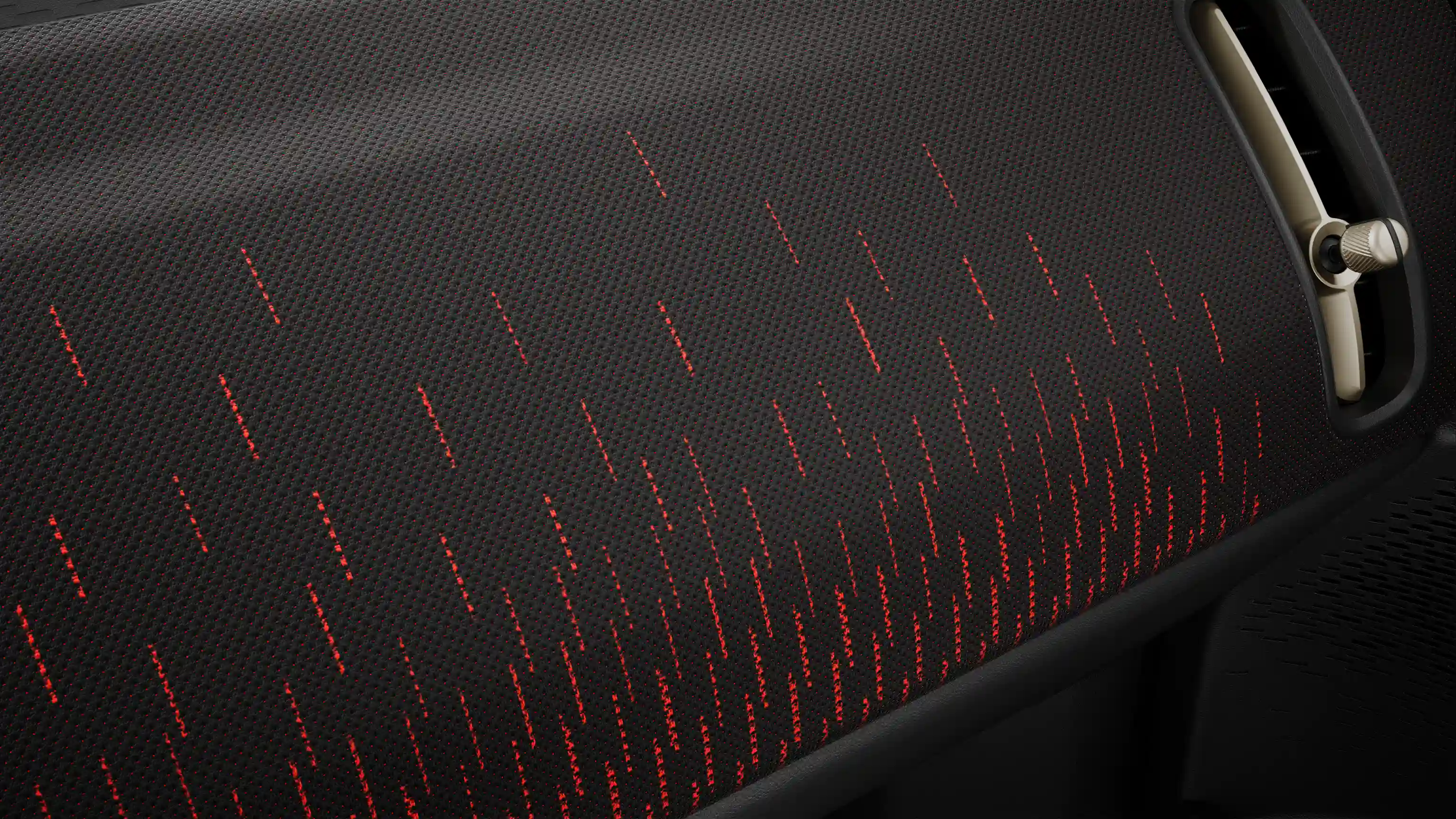 Skats uz pilnībā elektriskā MINI Countryman JCW Style priekšējo paneli sarkanā un melnā tonī