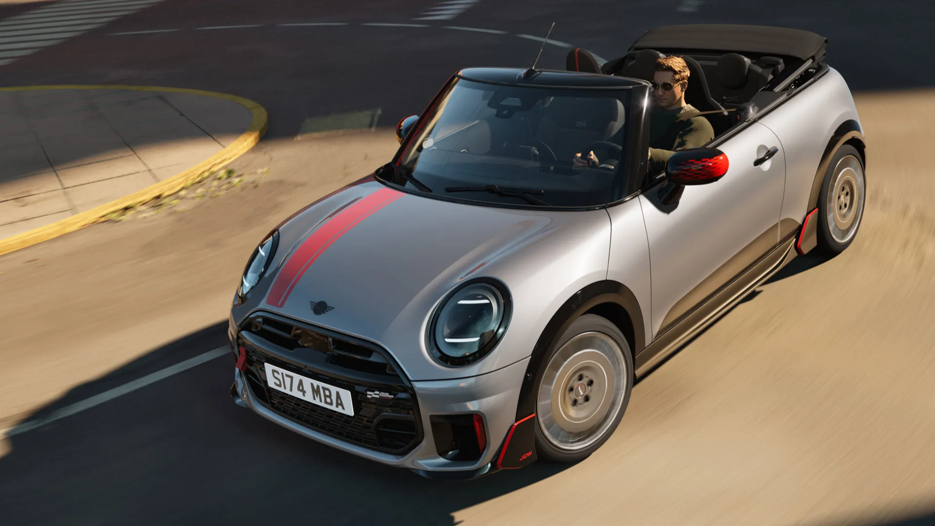 Skats no augšas uz MINI Convertible priekšpusi ar John Cooper Works uzlīmēm Chili Red krāsā.